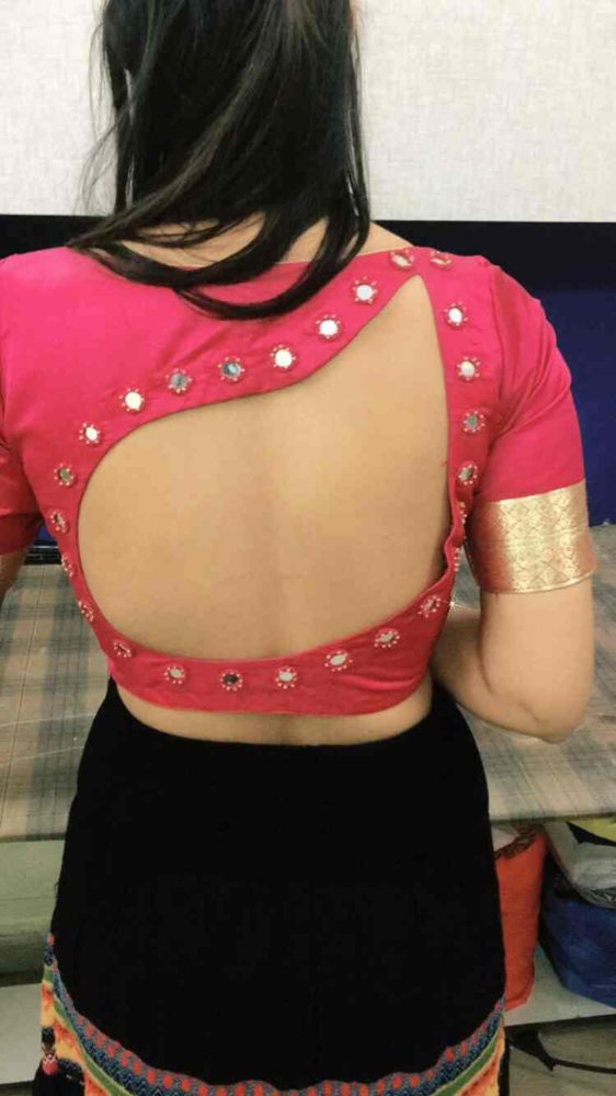 Custom pink blouse with a cut-out back stitched at Vastravan