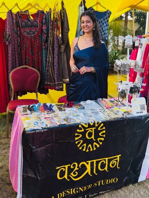 Ayushi Pandey at the Vastravan stall with the gold sun logo